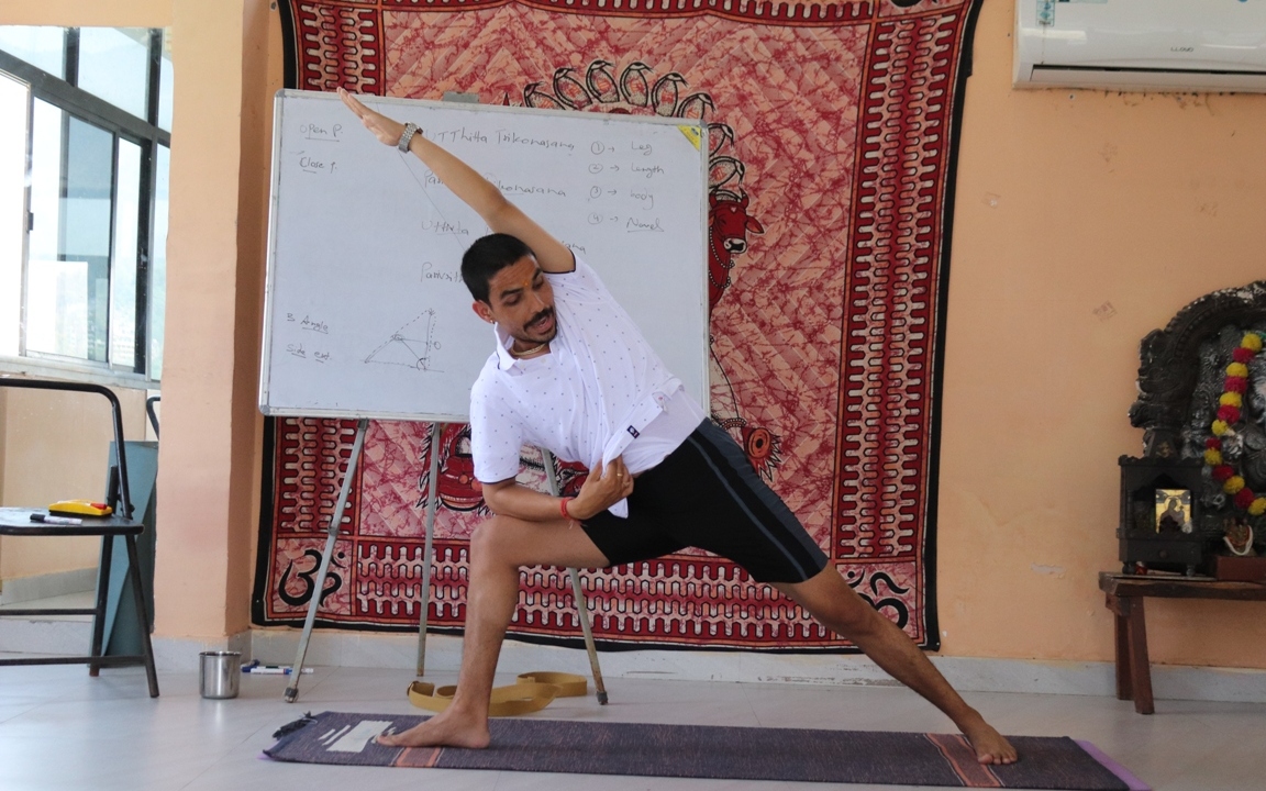 Yoga teacher conducting virtual yoga class at home on a video